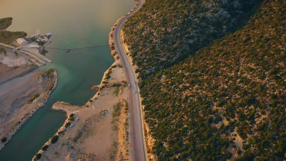 Aerial Drone View of Mountain Road with Driving Cars and Tropical Island