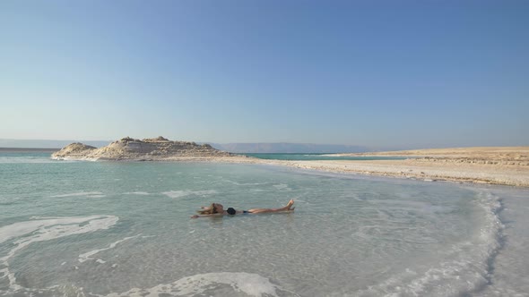 Girl Is Relaxing And Swimming In Water Of Dead Sea In Israel