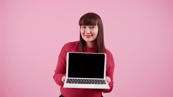 Adorable Longhaired Brunette Caucasian Girl with Bans Standing in Studio Over Pink Background