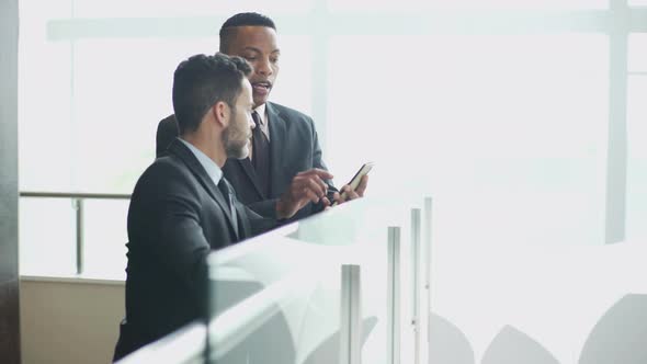 Business professionals looking at office building interior