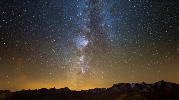 Time Lapse of the Milky way and the stars in summer night sky rotating over the Alps