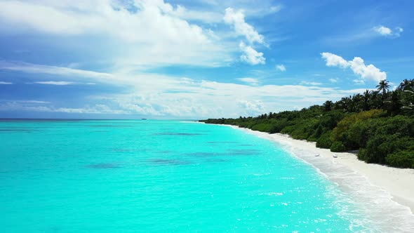 Natural aerial copy space shot of a sandy white paradise beach and aqua blue water background