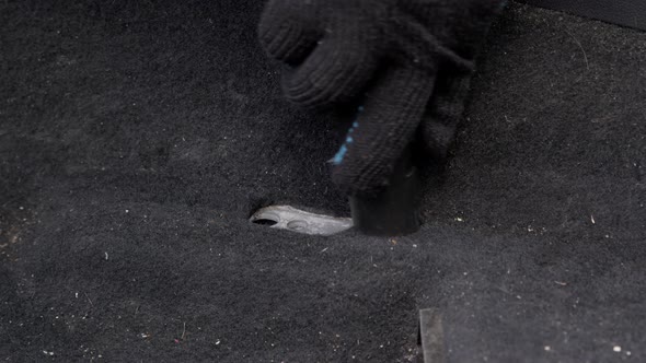 Male Worker Removes Debris From the Passenger Compartment of a Car with a Vacuum Cleaner.