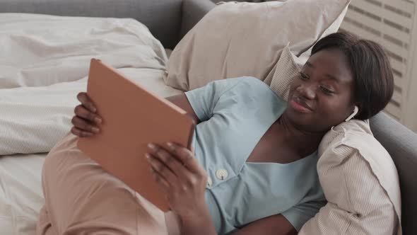 Young Woman Playing Video Game Using Tablet