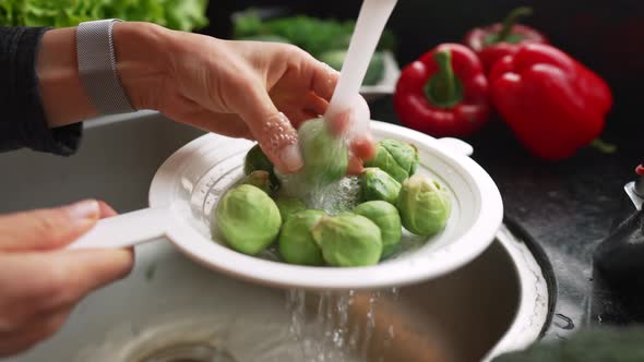 Washing the Brussels Sprout in Woman Hands