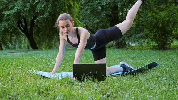 Athletic Sportswoman Doing Workout Doing Fitness Exercises Use Laptop Outdoor