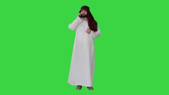 Emirate Arabian UAE Sheikh Businessman Making a Call on a Green Screen, Chroma Key.