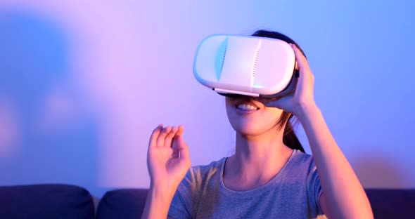 Woman play with VR device with purple and blue light