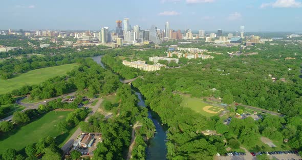 A view of Zikler Park and Barton Springs in downtown Austin, Texas. Flying over Barton Creek towards