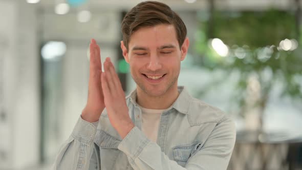 Portrait of Creative Young Man Clapping Applauding