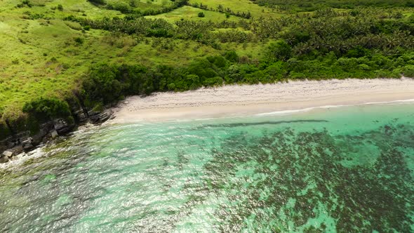 Tropical Island with a Turquoise Lagoon and White Sandy Beach Top View