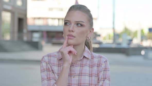 Portrait of Pensive Young Woman Thinking Outdoor