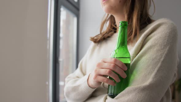 Woman Alcoholic Drinking Beer From Bottle at Home
