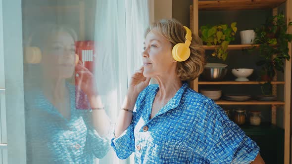 beautiful senior woman spending time in her house