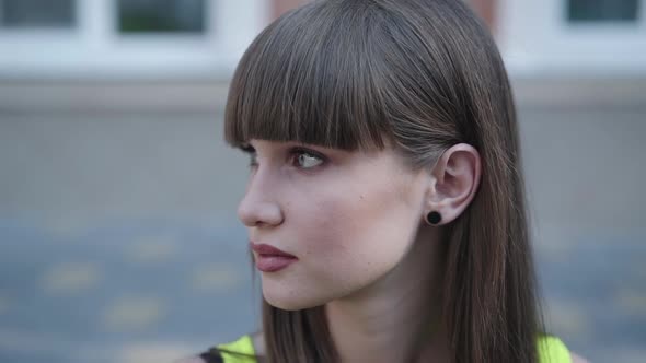 Serious Look of Beautiful Girl on a Street