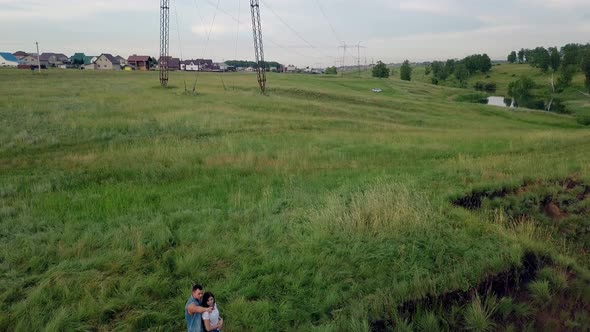 Aerial View Young Couple Hugs and Admires Countryside