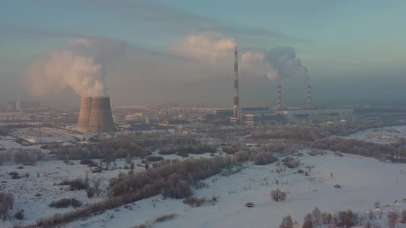 The Thermal Power Plant Works at Full Capacity in the Cold Winter During the Day Near the City