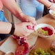 Three young women preparing fruit salad in kitchen, Italy - VideoHive Item for Sale