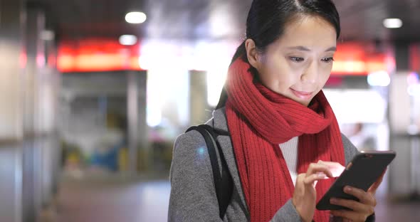 Woman look at mobile phone at night