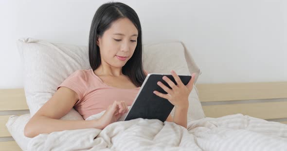 Woman Working on Digital Tablet Computer at Home