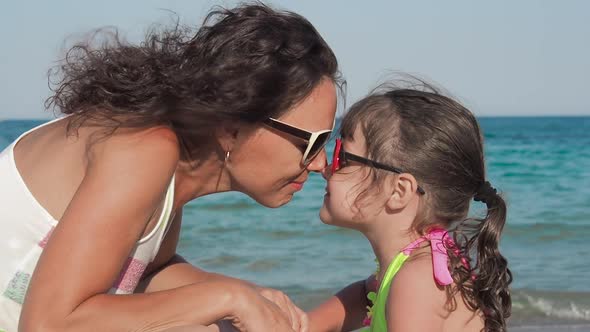 Portrait of Mother with Daughter on the Beach