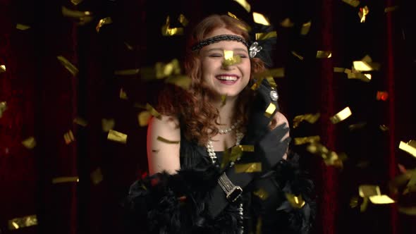 Excited Retro Styled Woman Dressed in Roaring Twenties Era Dancing and Smiling Under Confetti Rain