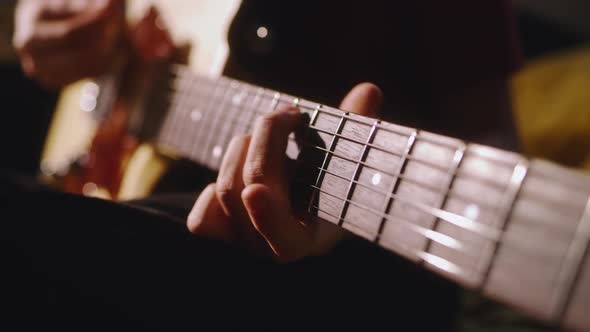 Crop Teenager Practicing to Play Guitar