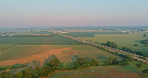 Panorama Landscape View in Sunrise Over the Meadow Across High Speed Highway in the Morning Fog in