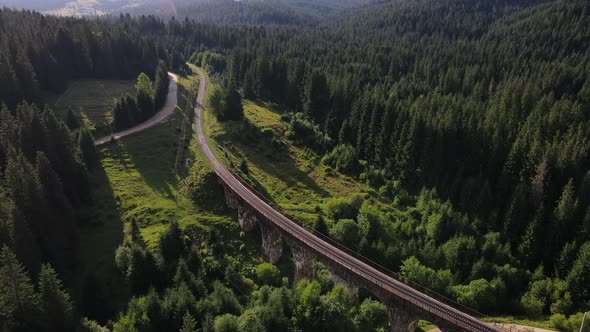 Beautiful Old Viaduct with Railway Between Green Hills with Pine Forest Ukraine