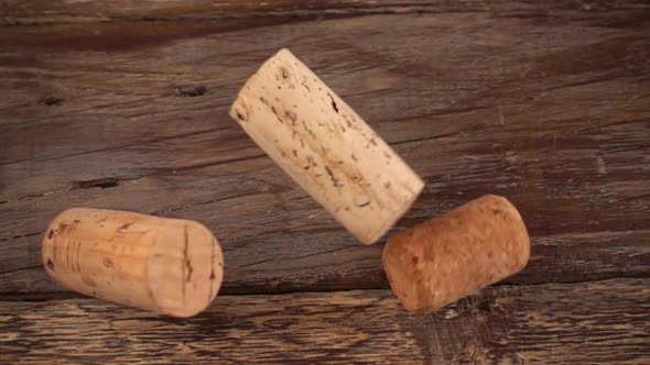 Falling wine corks on old wooden vintage boards. Slow motion.