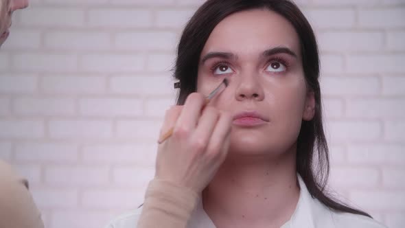 Portrait of a Woman in a Process of Preparing for the Photo Session