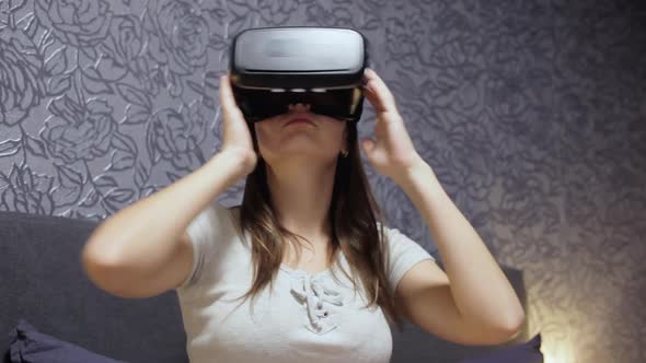 Beautiful Young Woman Wearing VR Headset at Bedroom