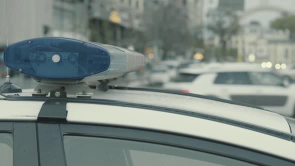 Flashing Flasher on the Roof of a Police Car. Blinker. Close-up.