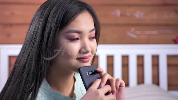 Closeup Happy Face of Young Asian Woman Flirting Writing Message Using Smartphone