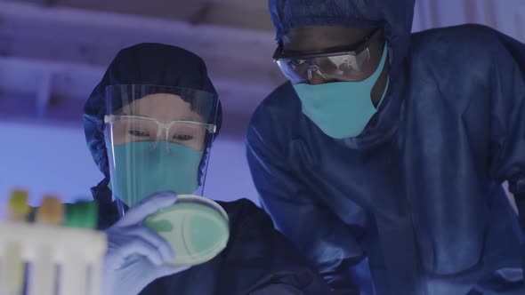 Diverse Biochemists Examining Petri Dish