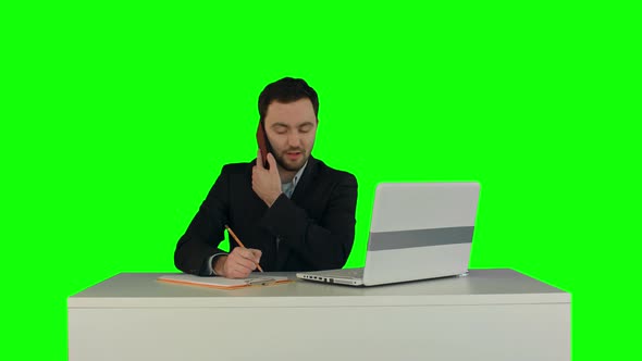 Young Business Man Speaking on the Phone in Office. on a Green Screen