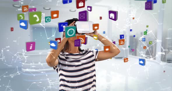 Woman using virtual reality headset with digitally generated icons 4k