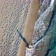 Aerial Drone Footage of a Girl Walking Along a Lonely Beach - VideoHive Item for Sale