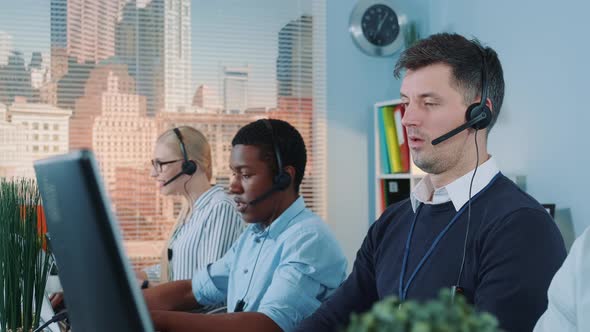 Close-up of Caucasian Call Centre Executive Helping a Client with a Sale By Talking on Phone