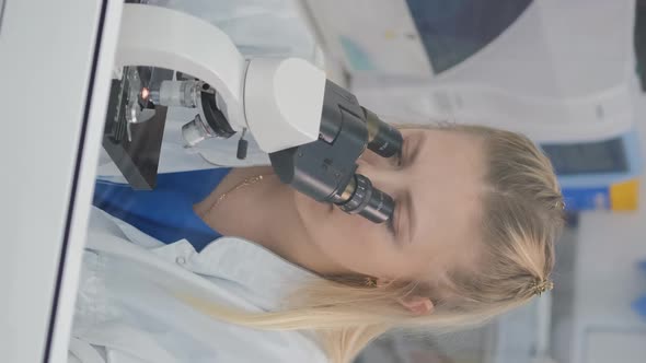 Female Scientist Using Microscope in Lab