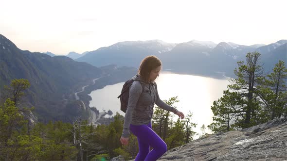 Adventurous Girl Hiking on Top of a Peak