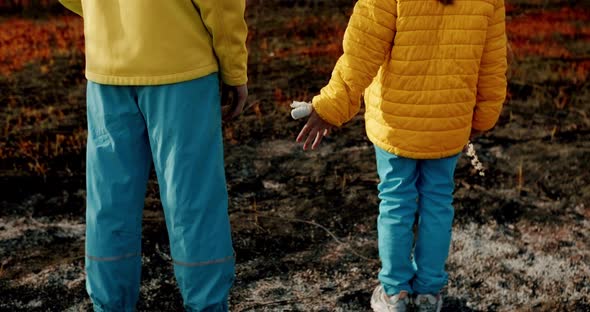 The Younger Sisters Dressed in the Colors of the Ukrainian Flag Holding Hands