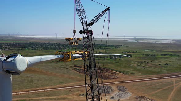 Massive Crane Is Holding a Blade of a Wind Turbine, Aerial Footage