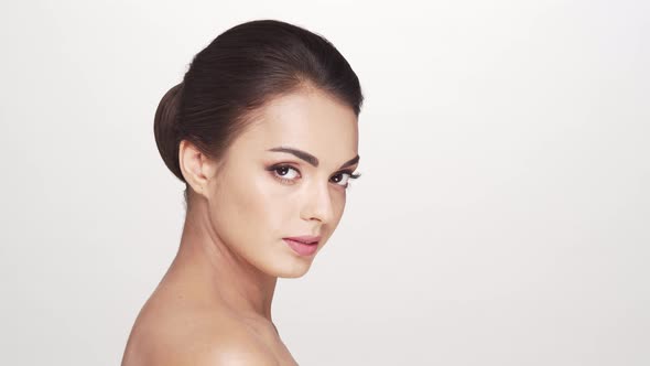 Studio portrait of young and beautiful brunette woman over