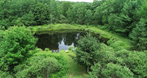 Drone baks up and rises to reveal the treeline of the Catskill mountains near Walton New York.