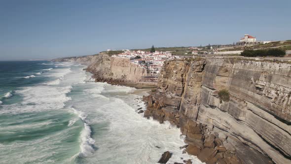 Majestic rocky cliff side colorful town of Azenhas Do Mar in Portugal, aerial view