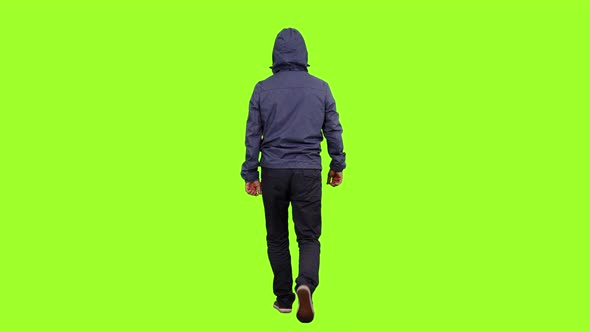  Hooded Man Walks on Green Background