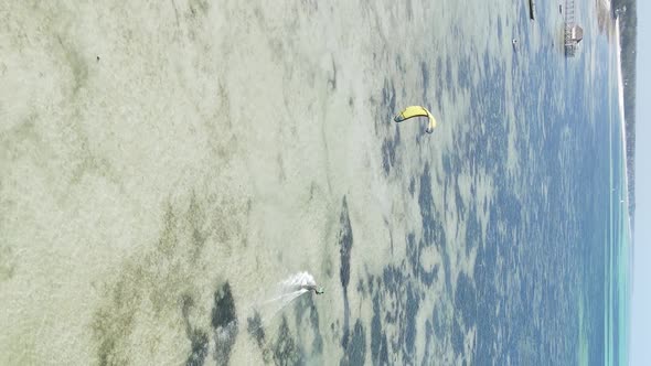 Vertical Video Kitesurfing Near the Shore of Zanzibar Tanzania Aerial View