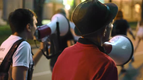 Anti Government Nonviolent Protest on City Streets with Bullorns and Megaphones