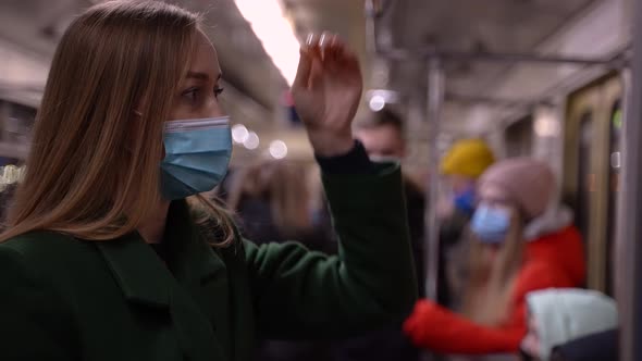 Pretty Woman in Medical Mask in Public Transport